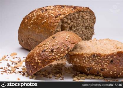 Fresh sliced bread with seeds on white background