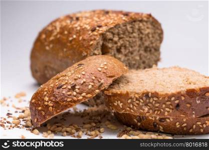 Fresh sliced bread with seeds on white background