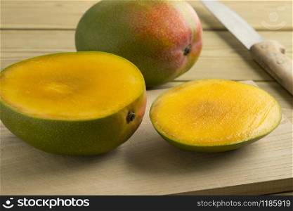 Fresh sliced mango and a whole one in the backgroundwhite background