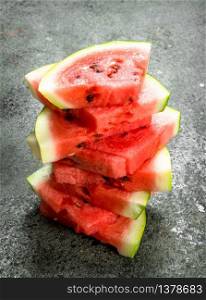 Fresh slices of watermelon. On a rustic background.. Fresh slices of watermelon.