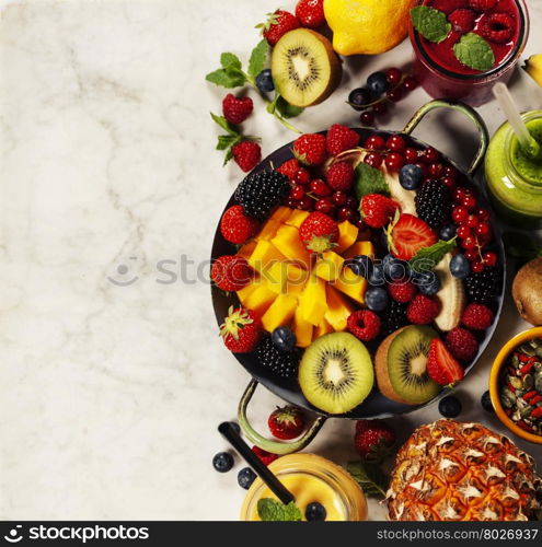 Fresh smoothies and fruits on marble table