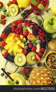 Fresh smoothies and fruits on marble table