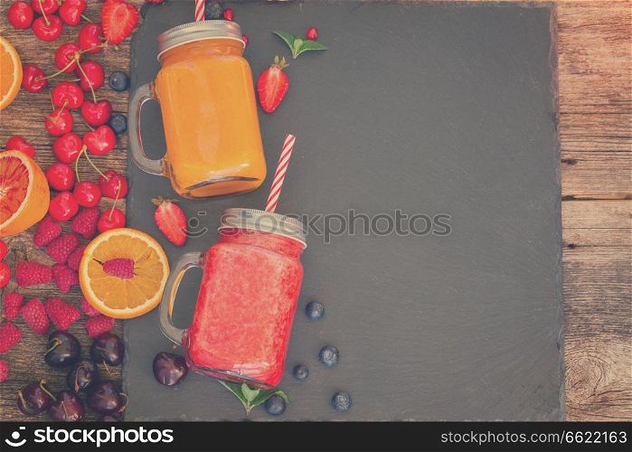 Fresh smoothy citrus and berry drinks with igredients and copy space, retro toned. Fresh smoothy drink with igredients
