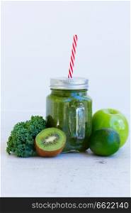 Fresh smoothy green drink in glass jars with igredients. Fresh green smoothy drink