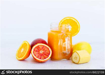 Fresh smoothy orange healthy drink in glass jars with igredients. Fresh smoothy orange drink