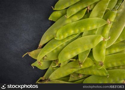 Fresh snow peas on slate background