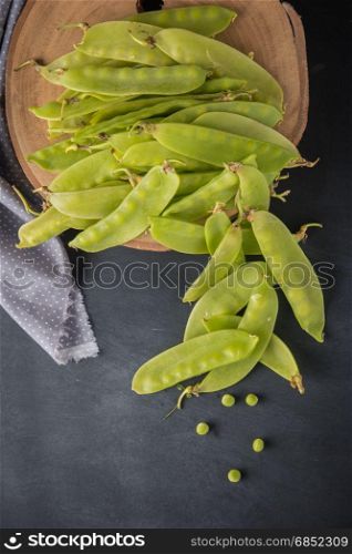 Fresh snow peas on slate background