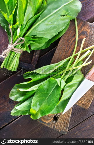 fresh sorrel on the wooden board and on a table