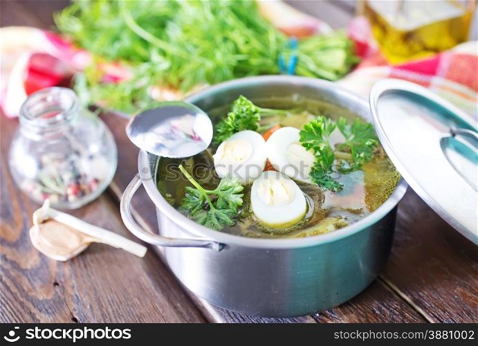 fresh soup with boiled eggon a table