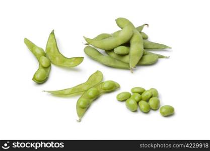 Fresh soybeans and pods on white background