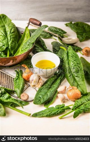 Fresh spinach cooking, preparation with pan,oil, garlic and nutmeg, close up