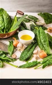 Fresh spinach cooking, preparation with pan,oil, garlic and nutmeg, close up