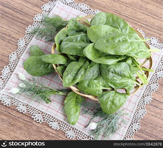 Fresh spinach leaves in a wicker basket