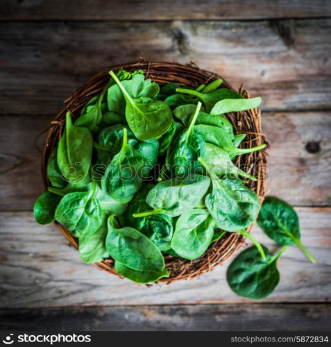 Fresh spinach on rustic wooden background