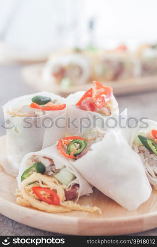 Fresh spring rolls on wooden table, stock photo