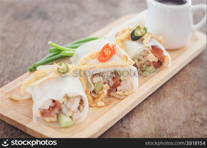 Fresh spring rolls on wooden table, stock photo