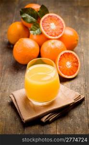 fresh squeezed orange juice on ancient wooden table