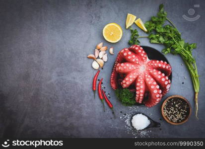 Fresh squid octopus cuttlefish dinner restaurant, Octopus food salad vegetable with garlic lemon chili salt coriander parsley and pepper on black plate for boiled cooked seafood