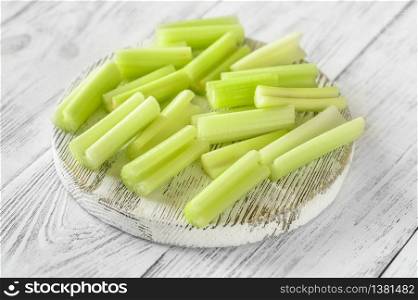 Fresh stalks of leaf celery on wooden board