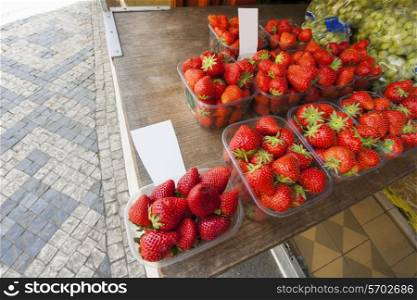 Fresh strawberries and grapes at outdoor market