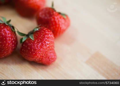 Fresh strawberries at wooden background
