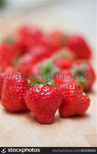Fresh strawberries closeup. Fresh strawberries at wooden background