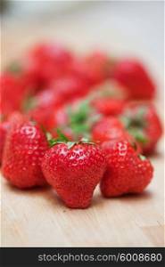Fresh strawberries closeup. Fresh strawberries at wooden background