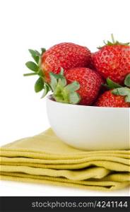 Fresh strawberries in bowl on green towel.