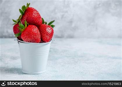 Fresh Strawberries in Small White Bucket Board on Light Background.. Fresh Strawberries in Small White Bucket Board on Light Background