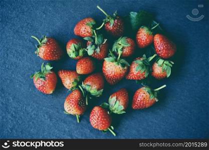 Fresh strawberries on black plate on the table, Red ripe strawberry on dark background
