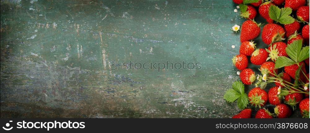 Fresh strawberries on old wooden background. Agriculture, Gardening, Harvest Concept