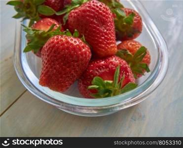 Fresh strawberries on old wooden background. Fresh ripe strawberries on a vintage wooden background