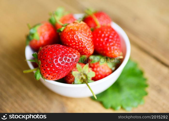 Fresh strawberries on white bowl on the table, Red ripe strawberry on wooden background