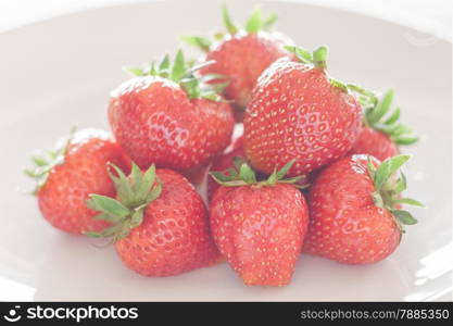 Fresh strawberries on white plate, stock photo