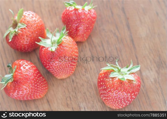 Fresh strawberries on wooden table, stock photo