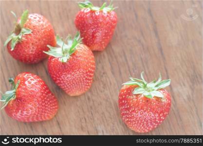 Fresh strawberries on wooden table, stock photo