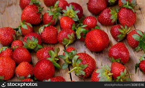 Fresh strawberries spinning on wooden table. Healthy eating concept. Fresh fruits background.