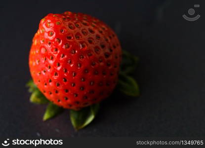 Fresh strawberries were placed on a black background. Copy space.. Fresh strawberries were placed on a black background