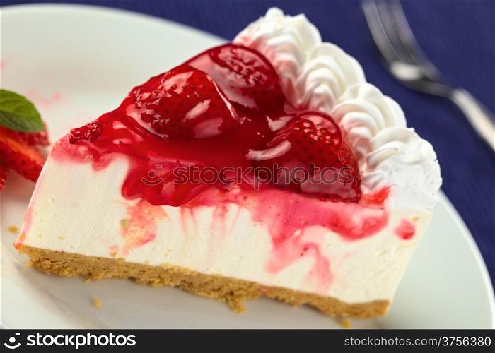 Fresh strawberry cheesecake (Selective Focus, Focus on the glazing running down on the left and the left side of the two strawberries in the front). Strawberry Cheesecake