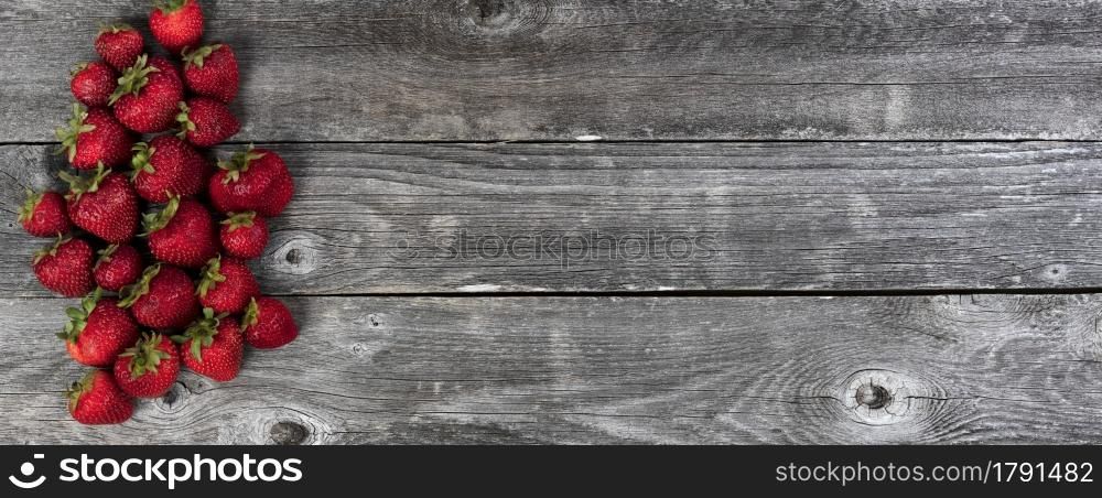 Fresh strawberry fruit on rustic wooden planks