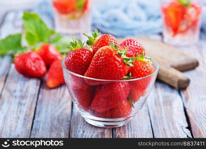 fresh strawberry in bowl and on a table