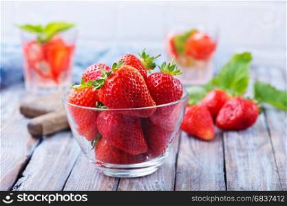 fresh strawberry in bowl and on a table