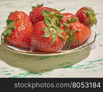 fresh strawberry lying on a plate closeup. strawberries on a plate