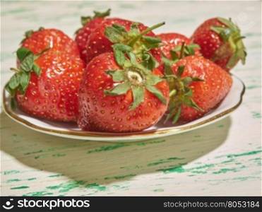 fresh strawberry lying on a plate closeup. strawberries on a plate