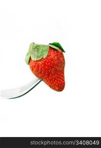 fresh strawberry on a fork over white