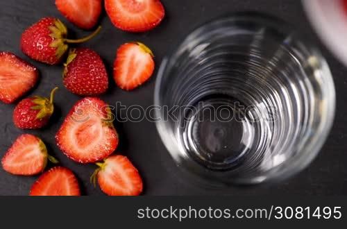 Fresh strawberry smoothie flowing in glass in slow motion. Healthy drinking concept.