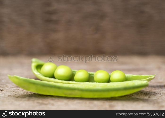 Fresh sugar snap peas in pod on rustic wooden background. Macro image of rersh Sugar Snap peas in pod