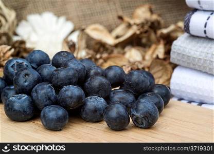 Fresh Summer blueberries on rustic wooden background