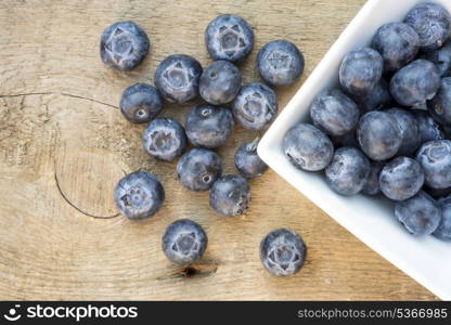 Fresh Summer blueberries on rustic wooden background. Macro image of fresh Summer blueberries