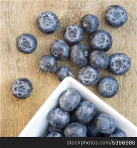 Fresh Summer blueberries on rustic wooden background. Macro image of fresh Summer blueberries